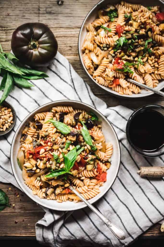 Savory roasted eggplant, umami-rich roasted tomatoes, briny capers, and sweet caramelized onions make this comforting veggie-packed pasta a must-have weeknight dinner.