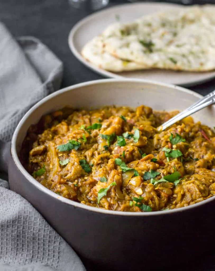 Baingan bharta is a smoky-flavored curry made by mashing fire-roasted eggplants and cooking them in a rich onion-tomato gravy. A popular North Indian dish, Baingan bharta pairs well with roti or rice.