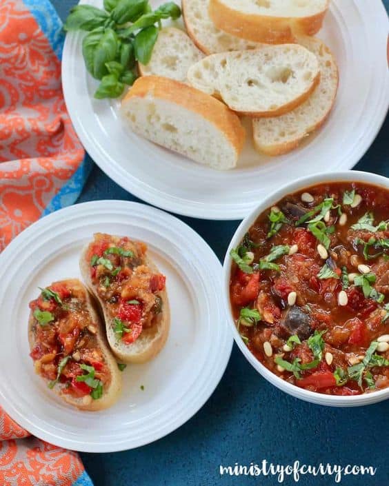 Eggplant and red pepper spread is a piquant ratatouille of soft-cooked eggplant, red peppers, and tomatoes with a perfect balance of spicy-tangy flavors and a hint of sweetness.