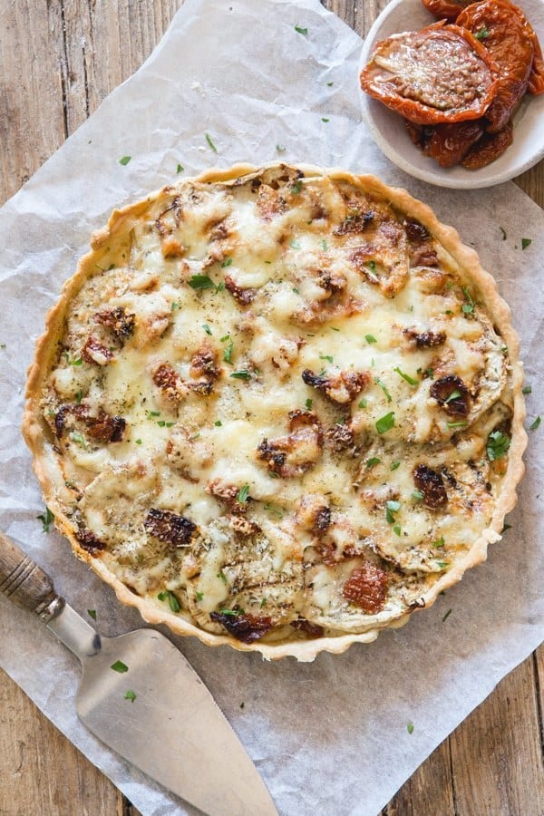 An easy Savory Pie, the perfect way to use up summer eggplant. Layers of eggplant, two types of cheese, spices and dried tomatoes. The perfect combination for an appetizer or main dish.