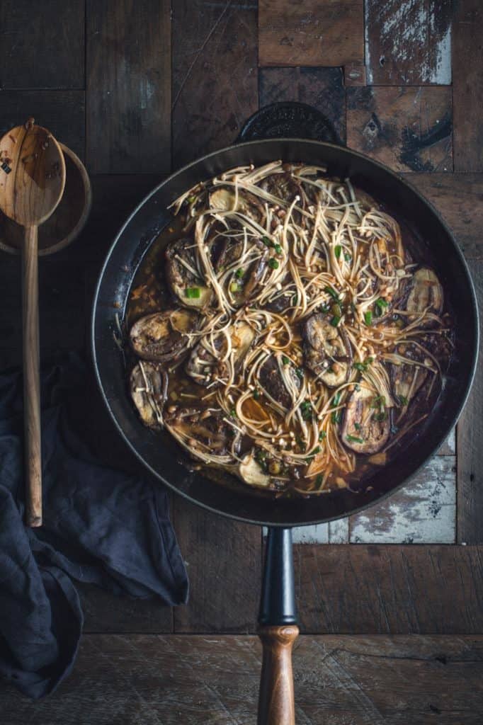 This spicy eggplant stir fry looks like a noodle dish but those gorgeous silky strands are enoki mushrooms! Perfectly gluten-free and low in carbohydrates, this noodle-not-noodle stir-fry is vegan and shove-in-to-your-face delicious.