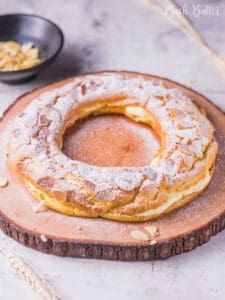 Almond choux pastry ring is a ring-shaped puff pastry filled with vanilla pastry cream and sprinkled with almond. A festive dessert perfect for big days like Christmas and family gatherings.