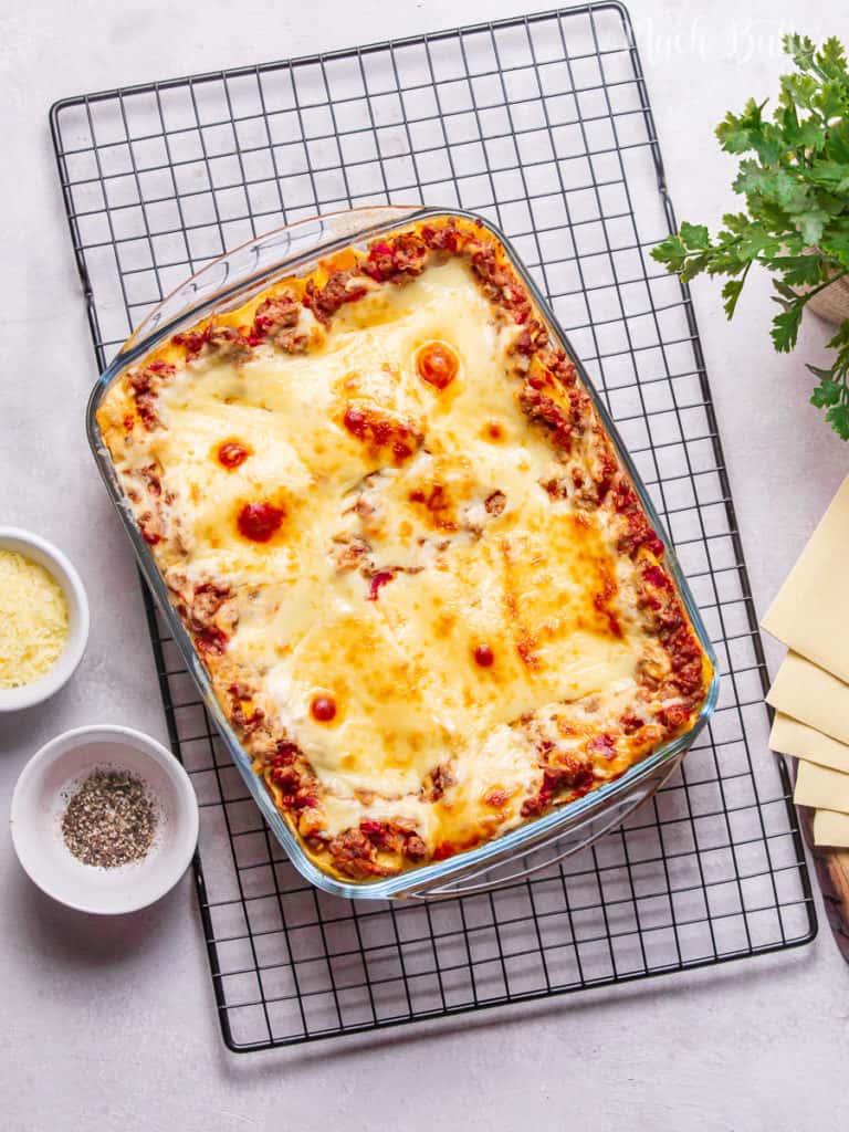 Classic Lasagna with bechamel sauce is the lovely comfort food for family and friends' dinner gatherings! Flavorful layered pasta with rich bolognese meat sauce, white bechamel sauce, and full of melted cheese.