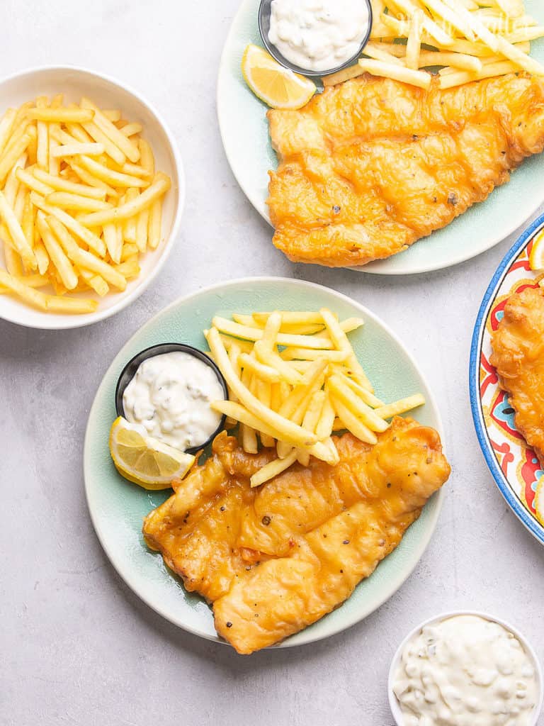 Fish and Chips with Tartar Sauce, Let's make England's favorite national dish! Crispy and golden brown flakey outside and tender inside. Perfect flavorful taste with a serving of crunchy chips and tartar sauce. No need to find the restaurant of fish and chips, just made it at home.