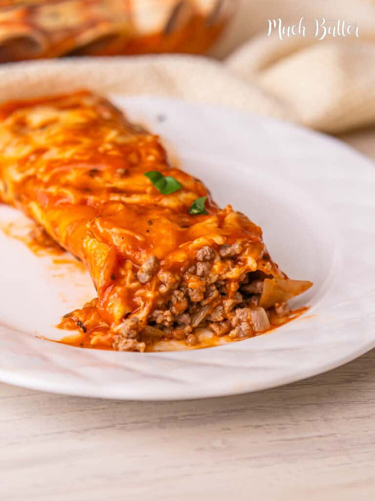 These Easy Beef Enchiladas recipe are made with a flavorful ground beef, soft tortillas, cheese, and all smothered in enchilada sauce 