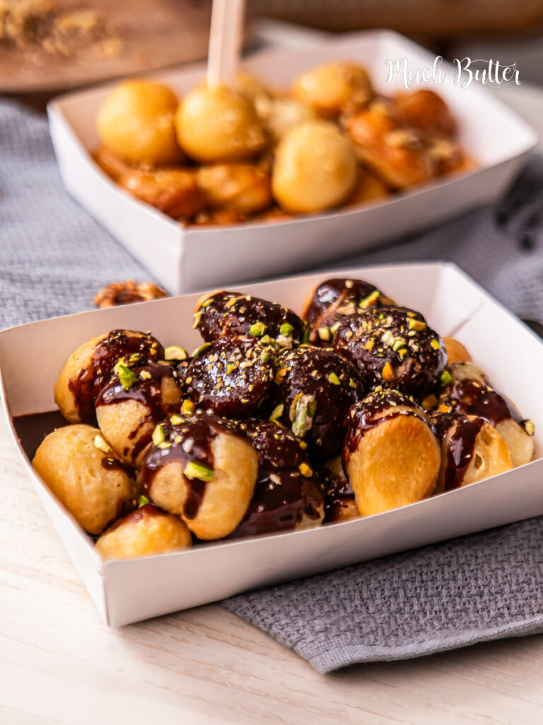Try Loukoumades, A Greek bite-size donut with crispy on the outside, fluffy on the inside, and soaked in sweet honey syrup.