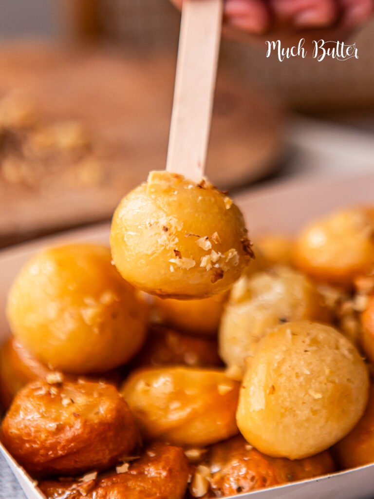 Try Loukoumades, A Greek bite-size donut with crispy on the outside, fluffy on the inside, and soaked in sweet honey syrup.