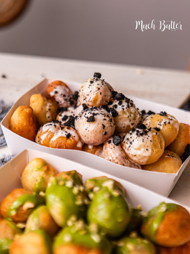 Try Loukoumades, A Greek bite-size donut with crispy on the outside, fluffy on the inside, and soaked in sweet honey syrup.