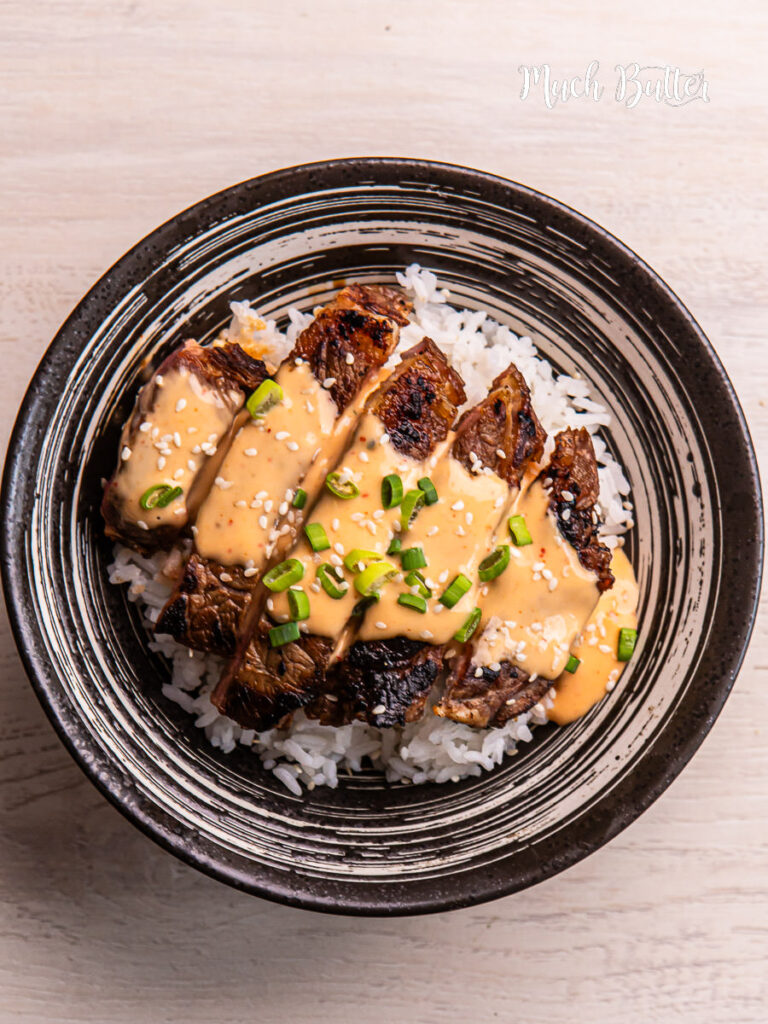 Korean BBQ steak rice bowl with creamy sauce is bold, savory, and incredibly satisfying. Tender slices of marinated steak are pan-seared to perfection!
