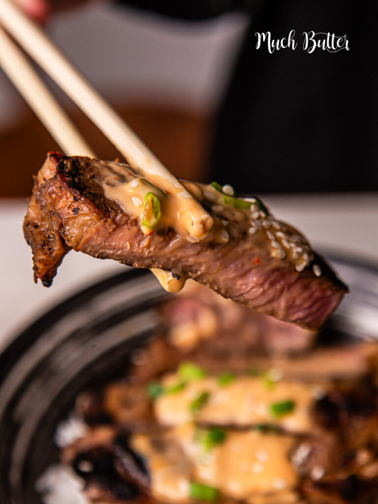 Korean BBQ steak rice bowl with creamy sauce is bold, savory, and incredibly satisfying. Tender slices of marinated steak are pan-seared to perfection!